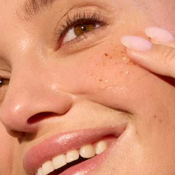 Woman applying Zombie mask on her cheek